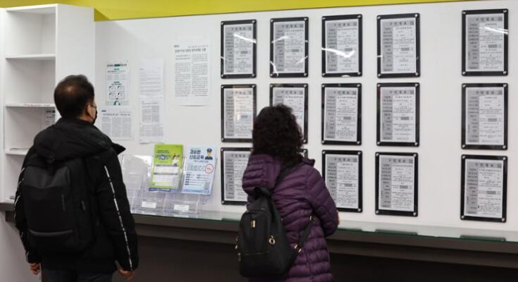 Job seekers check job placement at a job center in Seoul, in this file photo taken March 13.  Yonhap