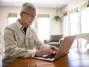 A senior looking at financial statements.