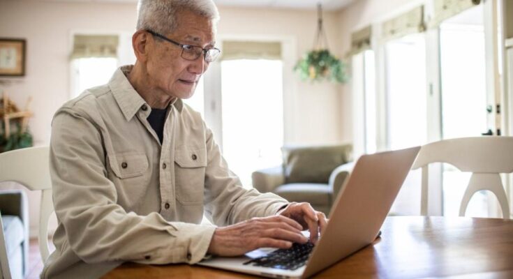 A senior looking at financial statements.